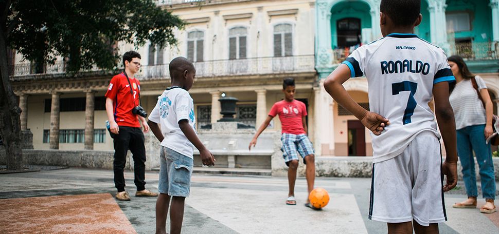 Andreas Xenopoulos with local children on the Paseo de Prado.