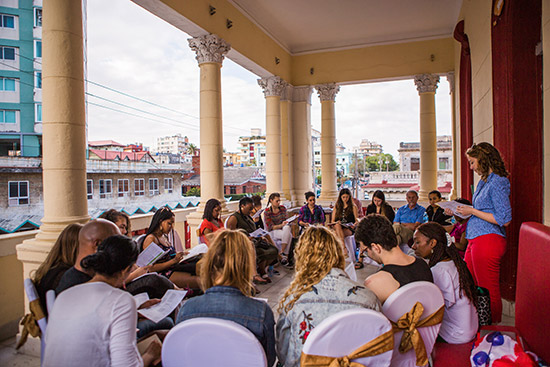 Trip coleader Julie Klinger leads a discussion on relations between Cuba and China on the balcony of Havana's Cazona 17 restaurant.