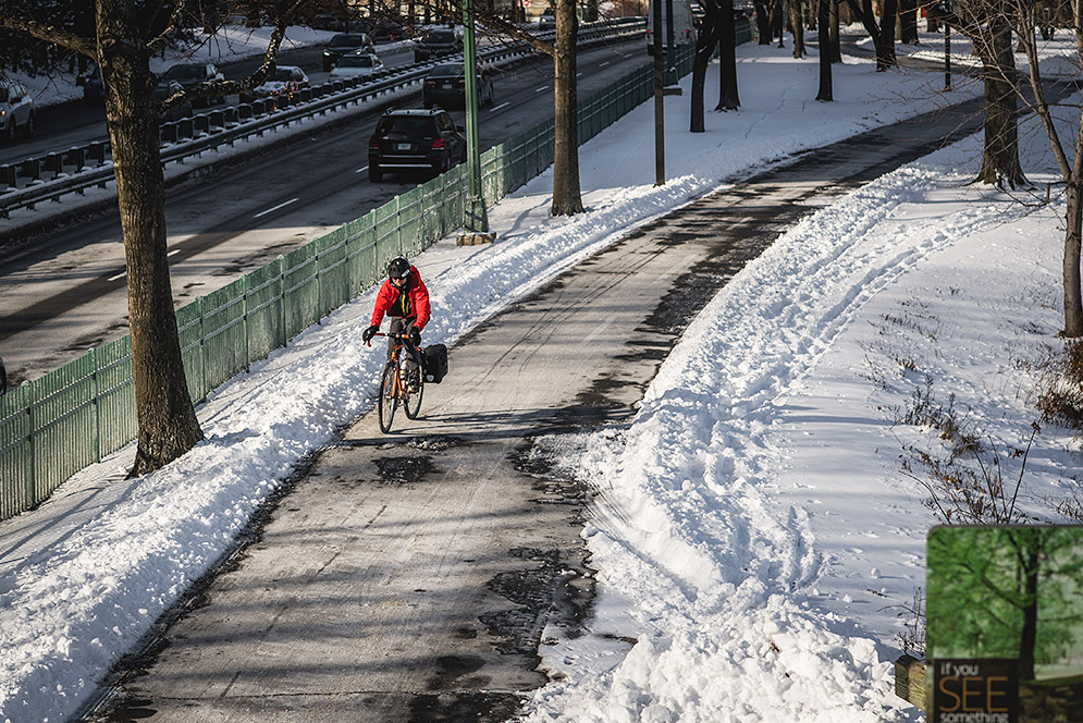 Bicyclist riding on path next to Storrow Drive