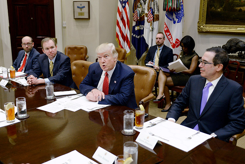 President Trump discusses the Federal budget in the Roosevelt Room of the White House. OMB director Mick Mulvaney sits to the President's right and Treasury Secretary Steven Mnuchin sits to his left.