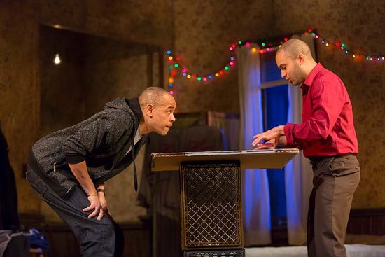 Matthew Harris and Tyron Mitchell Henderson perform on stage as brothers with a complicated relationship in the Huntington Theatre Company’s production of Topdog/Underdog