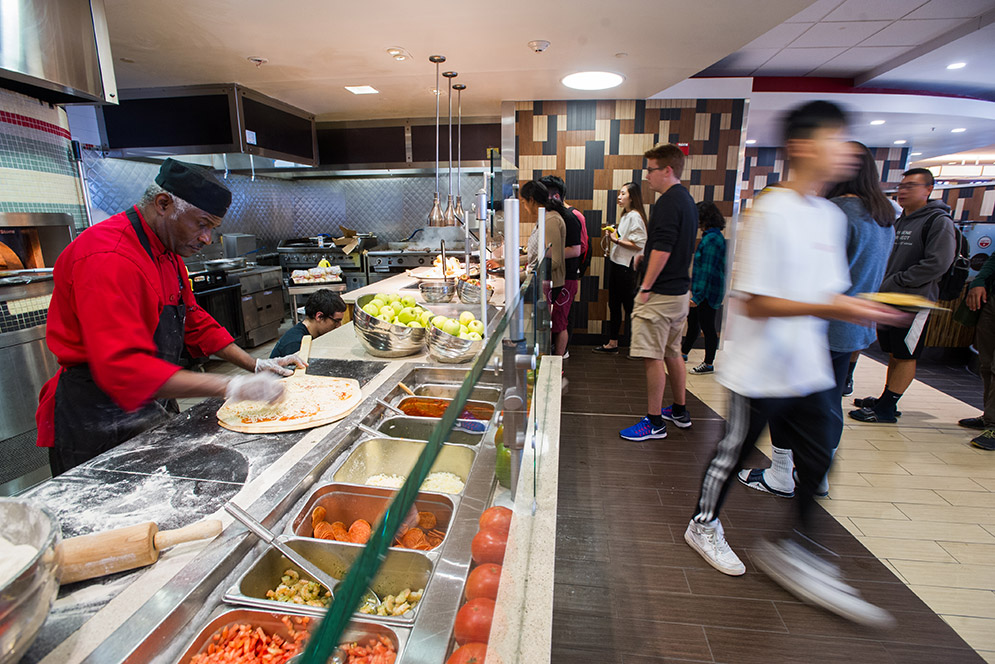 BU Dining Fresh Food Co cook Jean St. Joy makes pizzas int he Warren Towers dining hall