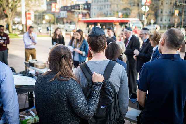 Members of BU community gathered in circle for candle lighting ceremony