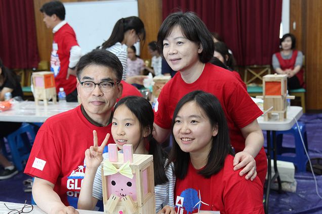 Young-chun Cho (clockwise from top left) his wife, Soojeong Kim, and their daughter Hyunjoo Cho work with an orphan from Dream Tree Village at a Global Days of Service event last year.