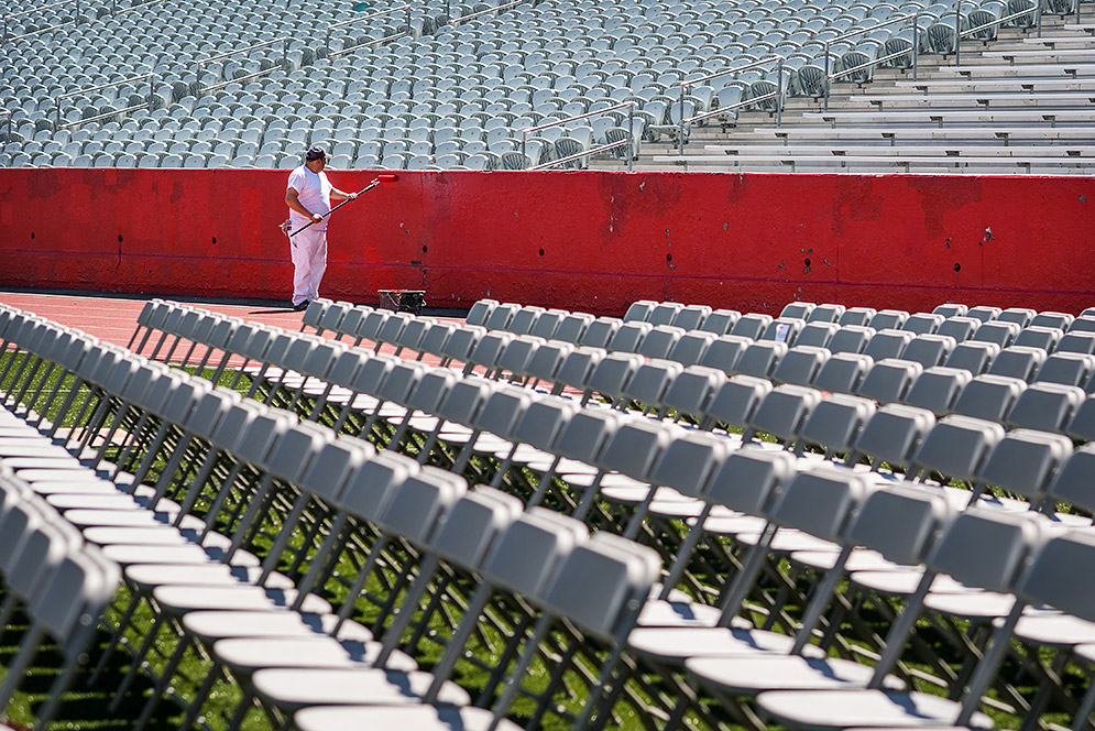 Freddy Franco of Wilder Painting refreshes the paint on Nickerson Field