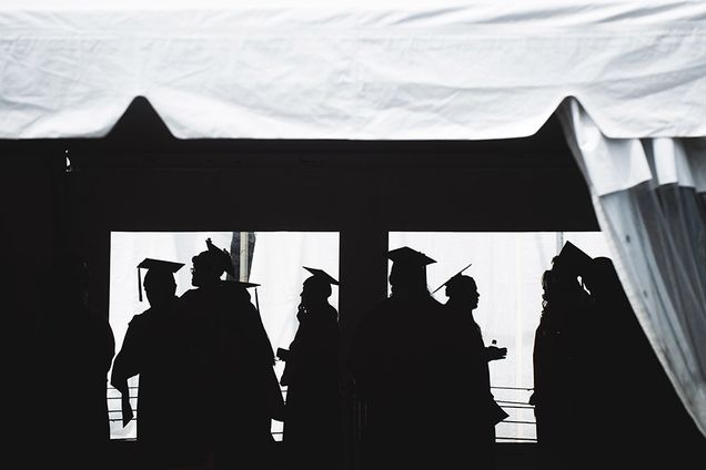 silhouette of BU students in caps and gowns