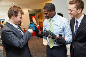 Team 8’s Richard Nesbit (from left), Fritz Jolivain, and Brett Moretzky demonstrating the Groove Gloves.