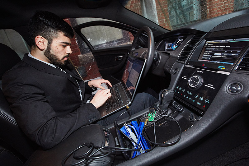 Omar Janoudi of Team 2 uses the group’s AutoPen software to hack into the computer systems of a Ford Taurus at ECE Day.