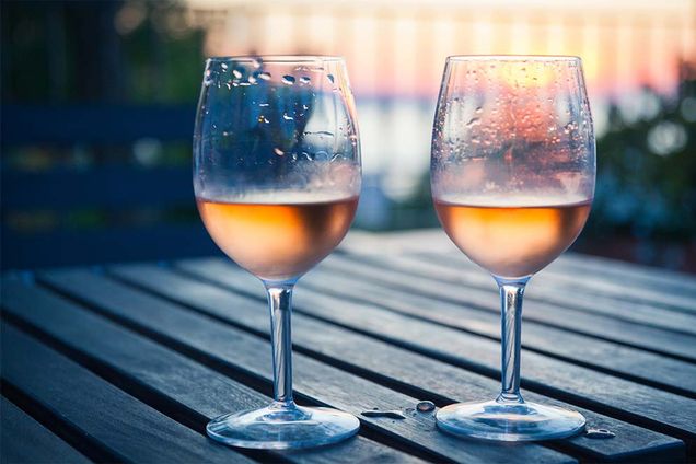 Two glass of chilled white wine on a table outdoors