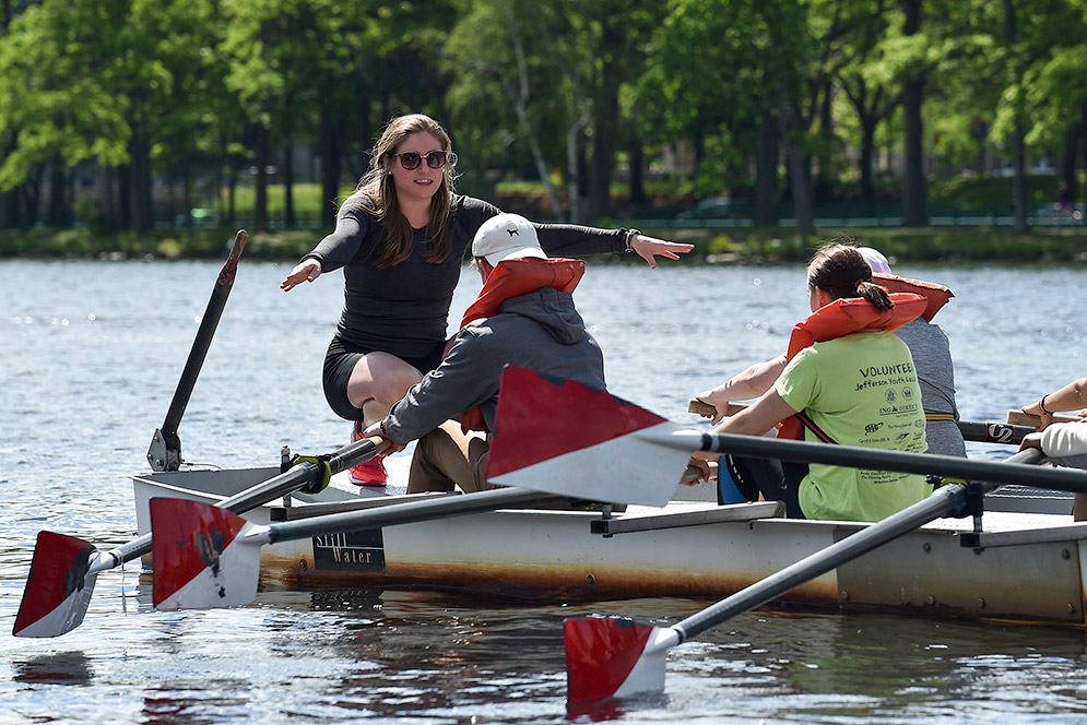 Gabrielle Himel teaching rowers in boat