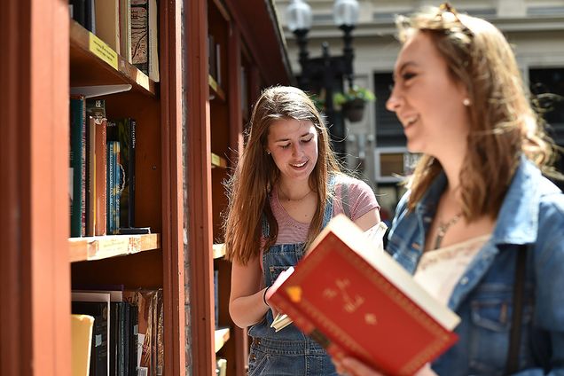 Annie Mooers and Maria Elisa Vallejo checking out books