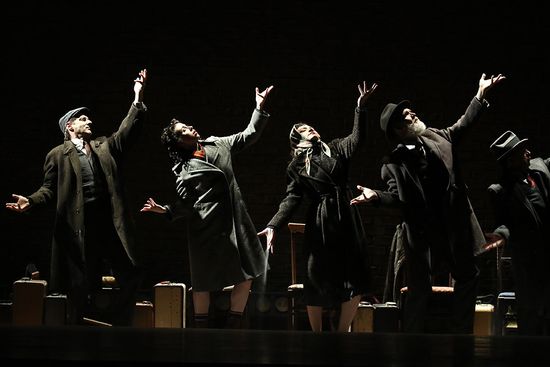 Actors on dark stage with dramatic lighting