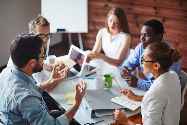 people in an office participate in a business meeting