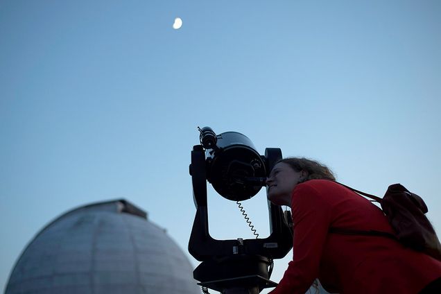 Elizabeth Henehan peers through a telescope to see moon