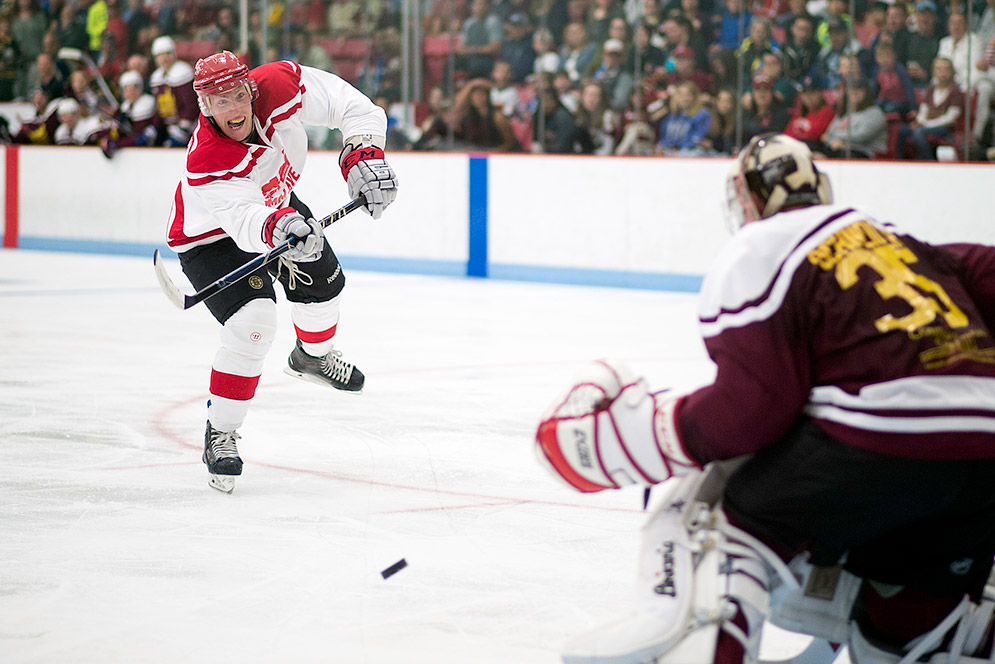 Kevin Schaeffer shoots puck toward Cory Schneider