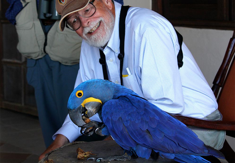 Ted Davis poses with a Hyacinth Macaw