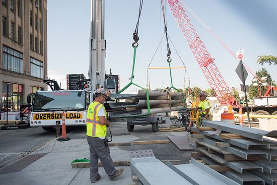 Worker directing placement of heavy materials