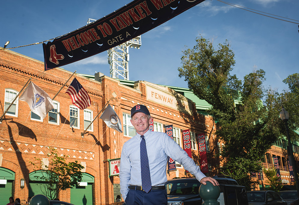 Professor Tom Whalen poses for a photo in front of Fenway Park