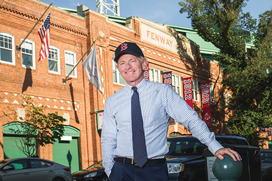 Professor Tom Whalen poses for a photo in front of Fenway Park