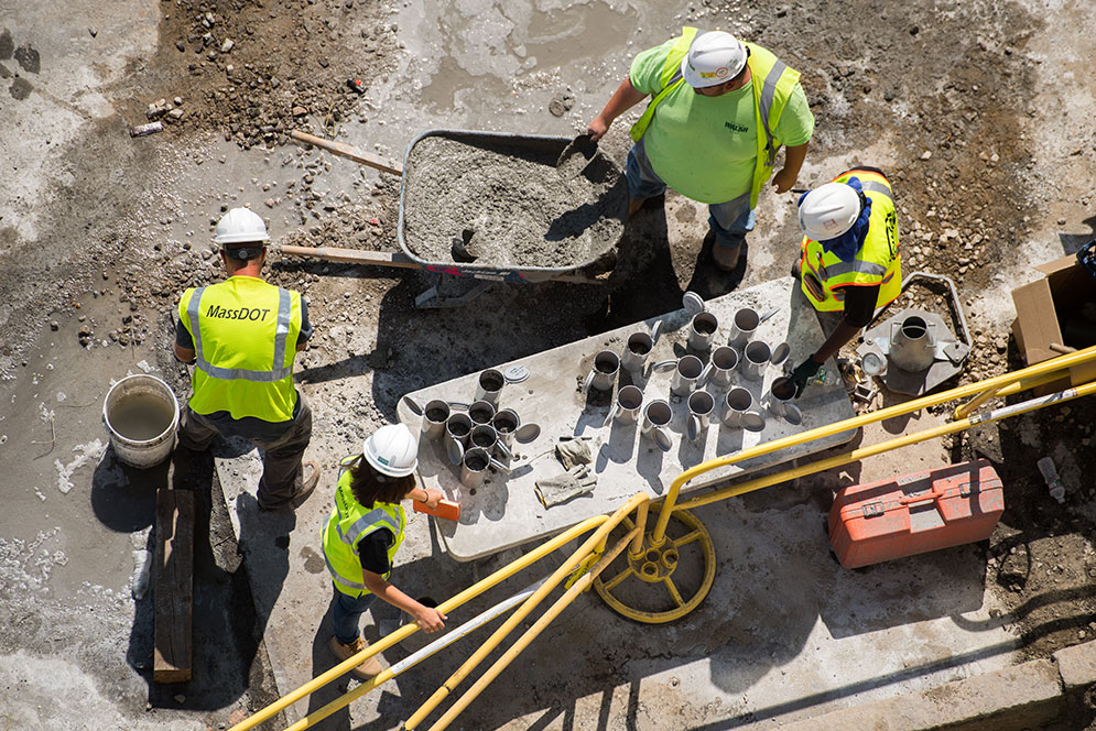 Aerial view of construction workers working with cement