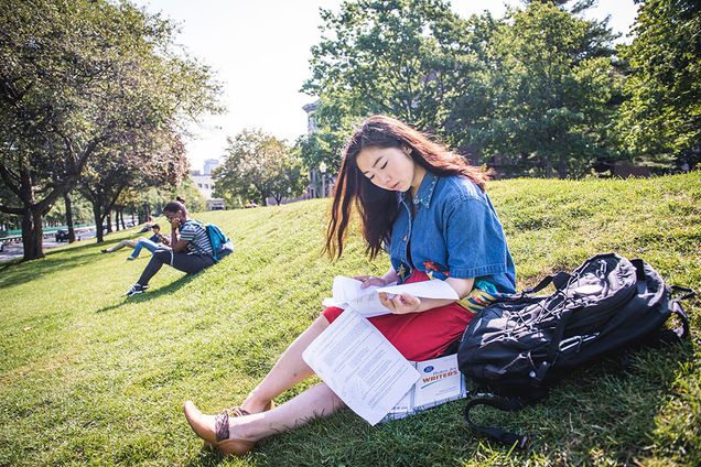 Posse Scholarship recipient, April Woo, reading on the BU Beach