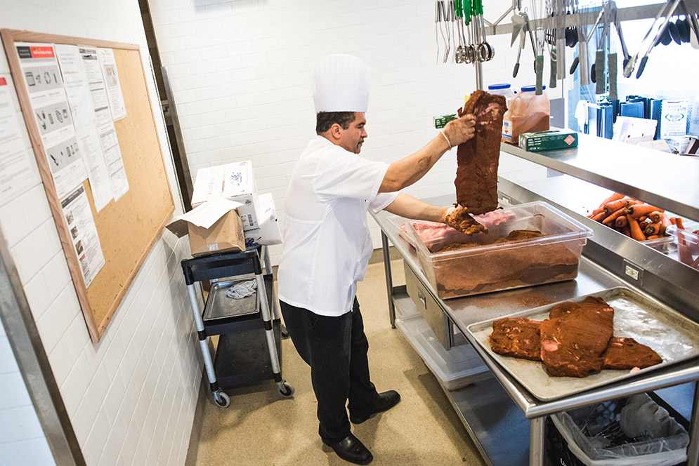 Executive Chef Orlando Andrade coats ribs with a cocoa spice mixture 