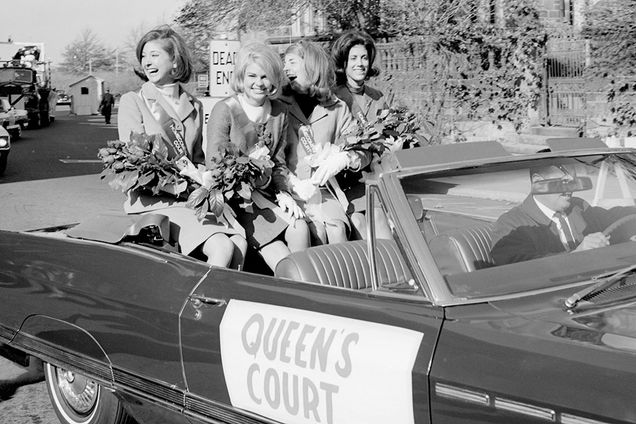 BU Homecoming Queen's Court gets a ride in a convertible in front of the BU Castle tbt
