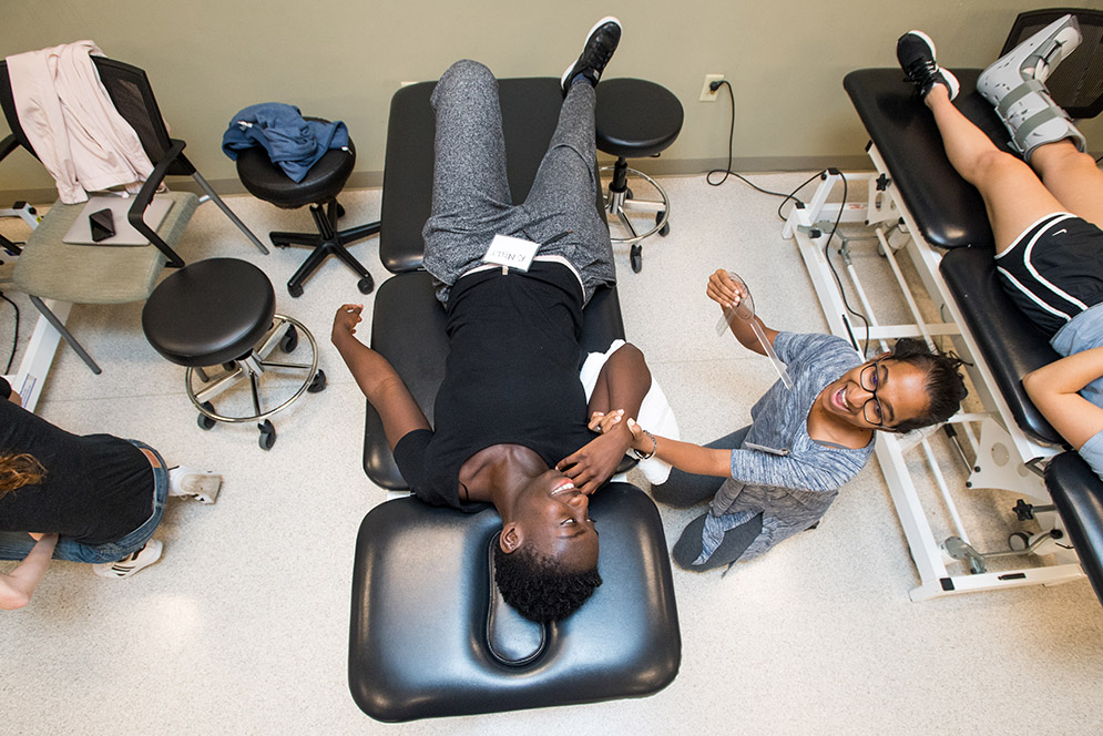 Arlene Kodjo (SAR'2) plays the role of patient while Varshini Balasubramanian (SAR'20) performs a range-of-motion assessment
