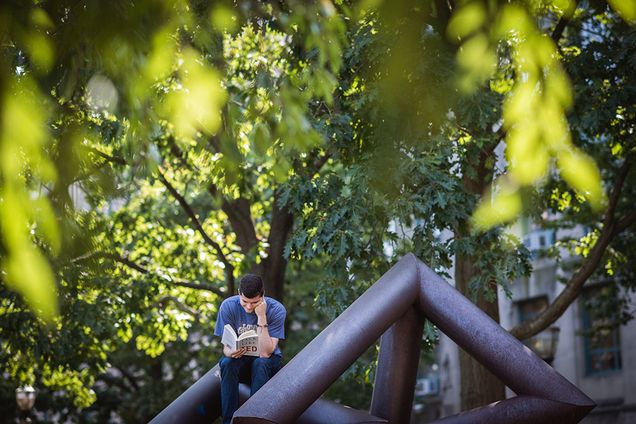 Ross Hurlock (CGS '18) reads "Talk Like Ted" by Carmine Gallo in Marsh Plaza