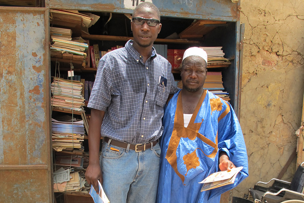 1) Fallou Ngom, a CAS professor of anthropology and director of the African Studies Center, with Amadou Ndiaye, an Ajami and Arabic bookseller in Saint-Louis, Senegal. Photo courtesy of Ablaye Diakité