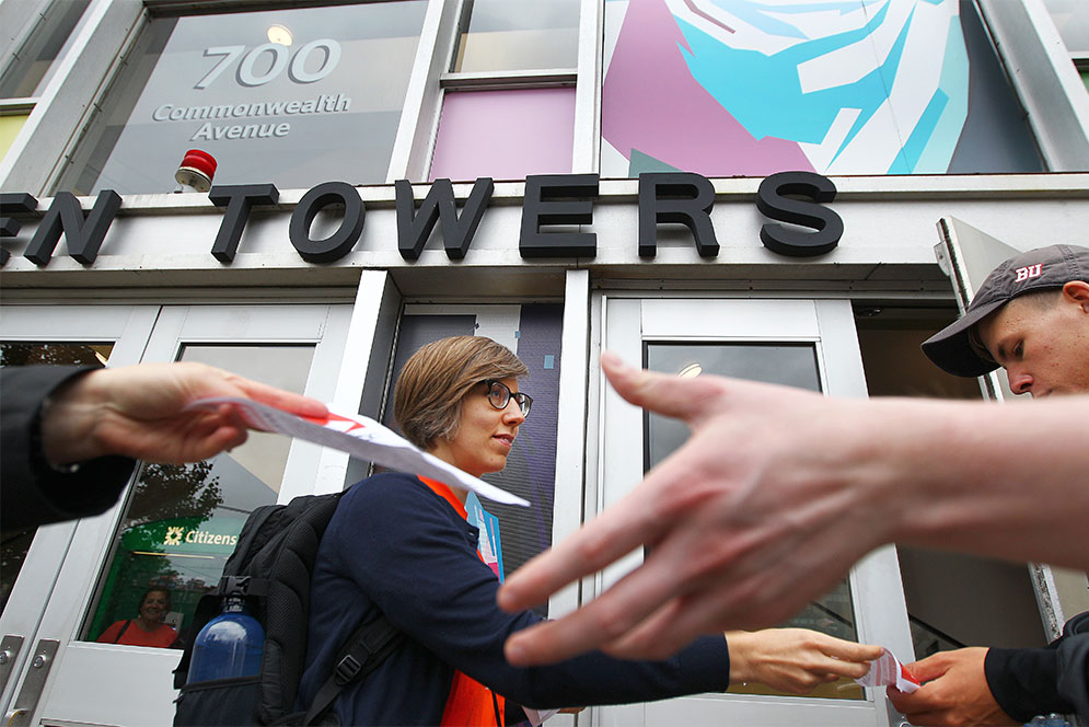 Boston University non-tenured lecturers stage an informational picket handing out flyers in front of Warren Towers during Fall Semester move-in weekend