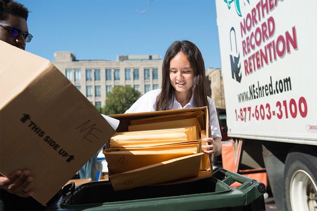 Sustainability@BU intern Qiyuan Fu (GRS’18) helps Daniel Mboweni (ENG’18) dispose of paper during day one of Information Security’s annual three-day paper shredding and electronic disposal