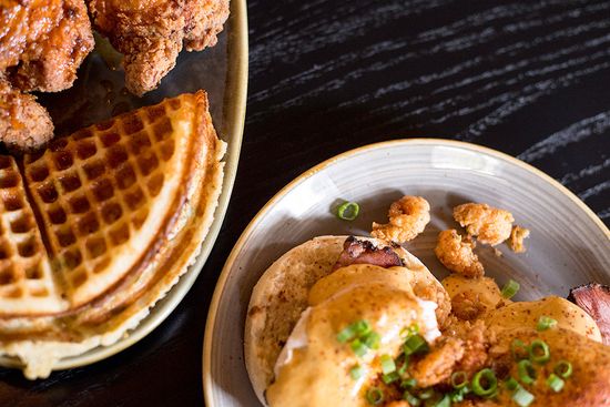 The chicken and waffles (left) is tasty and filling. The crawfish benedict (right) is made with tasso ham, topped with fried crawfish and a hot Nashville hollandaise sauce. Photo by Maddie Malhotra (COM’19)