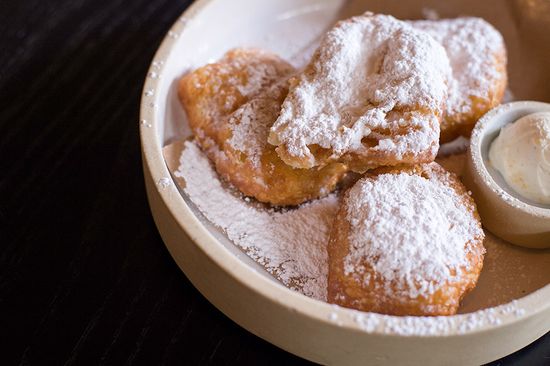 Pillowy beignets, dusted with powdered sugar and served with a side of sweet vanilla bean cream, round out a Buttermilk & Bourbon meal. Photo by Maddie Malhotra (COM’19)
