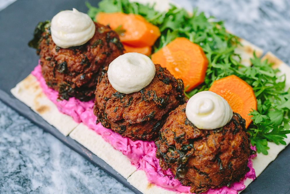 Carrot hummus dusted with fenugreek and almond dukkah, spinach falafel on petit strips of lavash with tahini at Oleana restaurant in Cambridge, MA