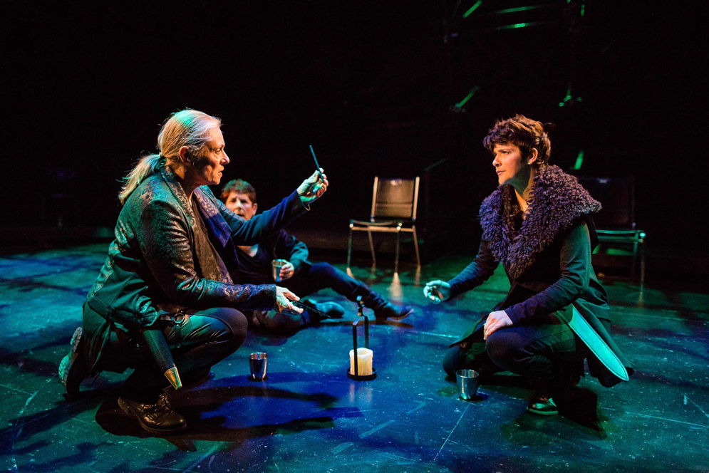 Actresses kneel on stage in the all-female production of Julius Caesar.