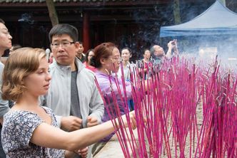 Clarinda lights bright pink incense in China.