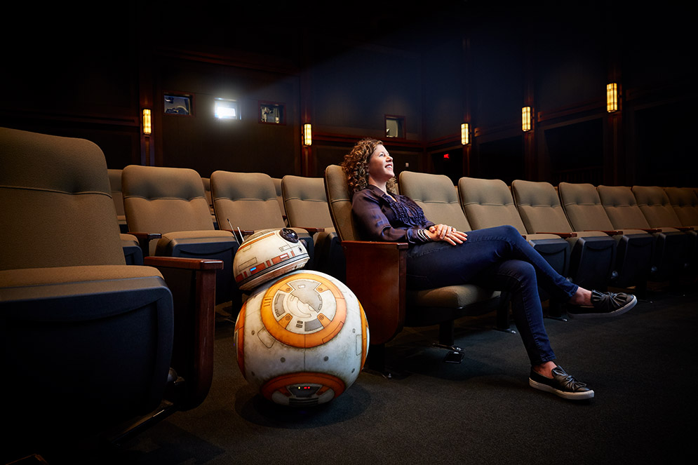 Janet Lewin (CGS’90, COM’92), with droid BB-8 in a screening theater at Lucasfilm in San Francisco, takes Star Wars’ groundbreaking visual effects from ambitious ideas to fully executed realities. Photo by Mitch Tobias