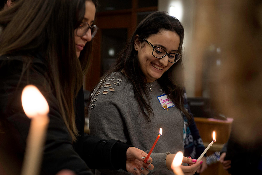 Boston University students light the menorah on the first night of Hanukkah 2017