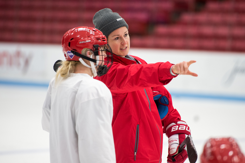 BU Ice Hockey Coach Tara Watchorn instructs a player during practice.