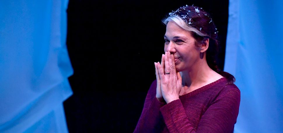 Playwright and actress Melinda Lopez smiling on stage