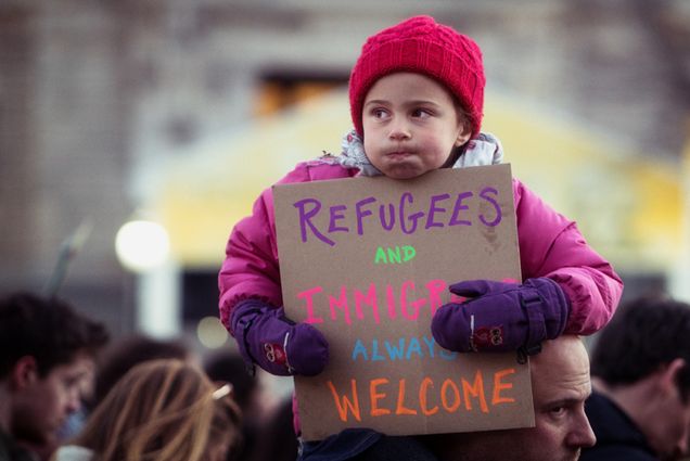 A child holds a protest sign