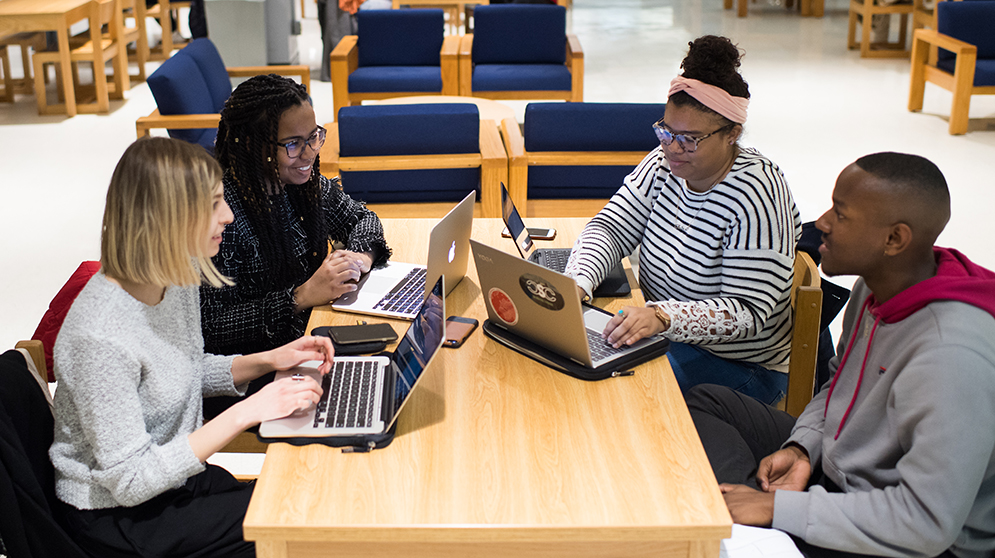 (From left) Charcoal magazine creators Eva Gallagher (CFA'39;19), Remy Usman (CFA'19), Adia Turner (CAS'19) and Bradley Noble (CAS'20) meet at the George Sherman Union on Thursday, February 1, to plan the launch of their first issue. Photo by Jackie Ricciardi.