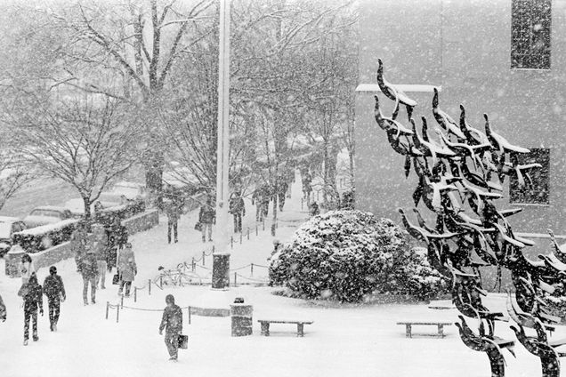 Students walk on the sidewalk near Marsh Plaza during a snowstorm in the winter of 1980.