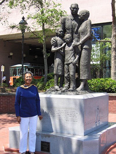 Abigail Jordan stands next to the African-American Slave Monument in Savannah, GA, which she helped erect