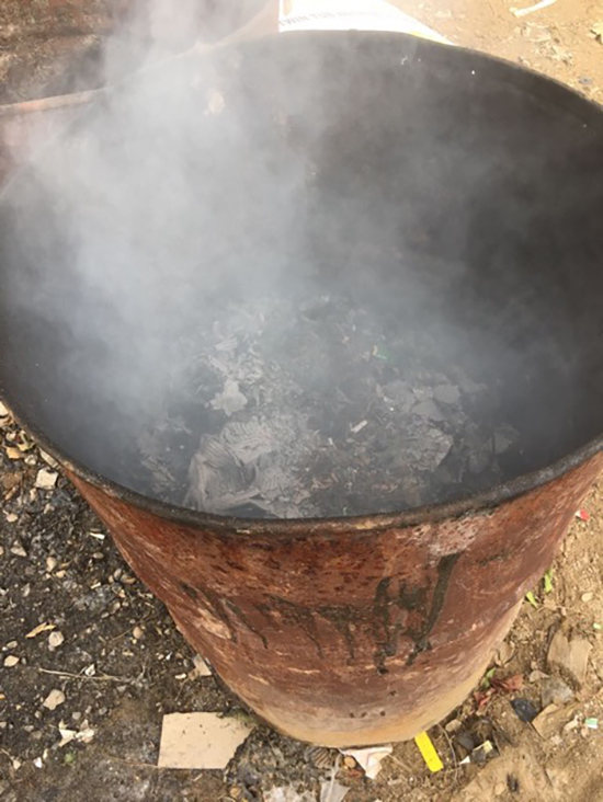 Cooking fire burns in a barrell at a Lebanon refugee camp