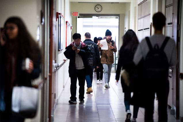 Boston University students walk the hallways before class