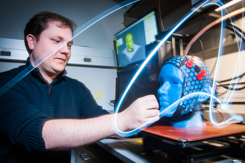 Postdoctoral fellow Bernhard Zimmermann works on a new wireless fNIRS system in the BU Neurophotonics Center lab.