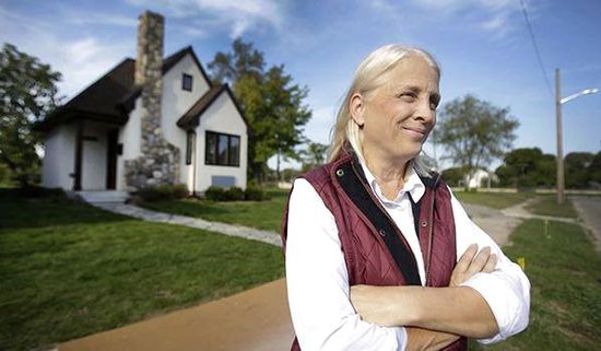 Faith Fowler stands outside one of her tiny homes in detroit 