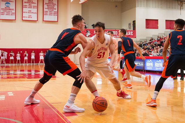 Boston University men's basketball player Max Mahoney drives towards the net during a game against Bucknell University